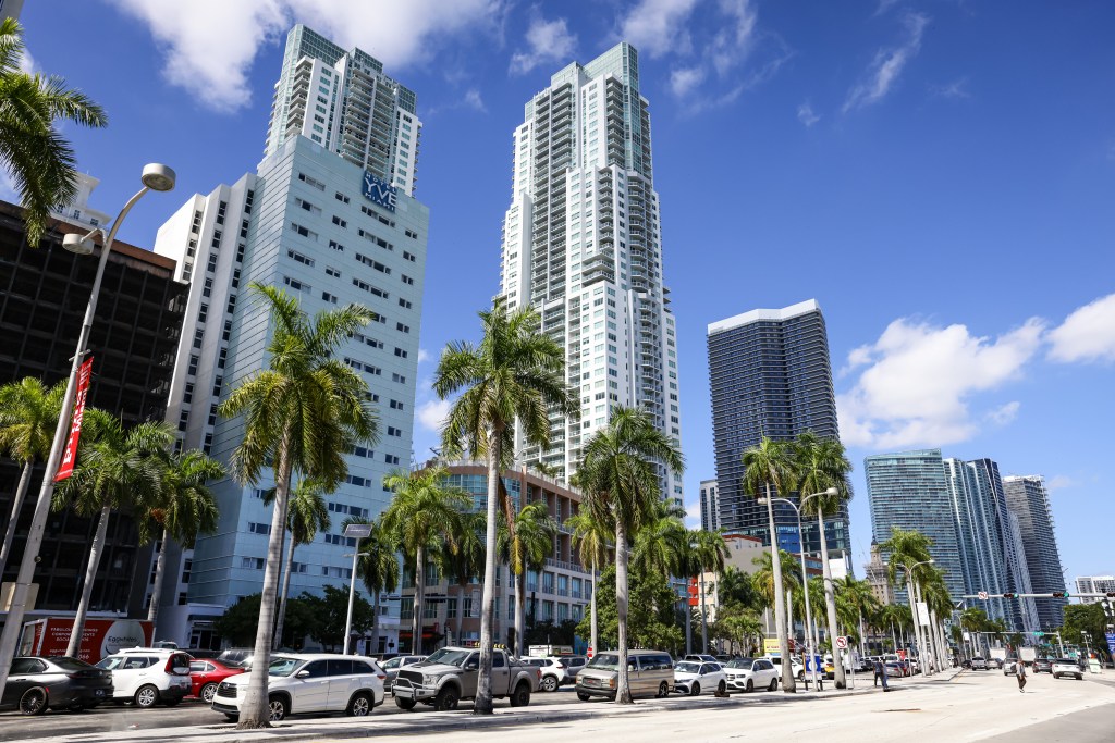 Downtown Miami skyline with commercial and residential buildings surrounded by palm trees